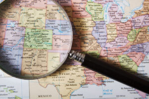 Public health mapping. Magnifying glass over map of the United States